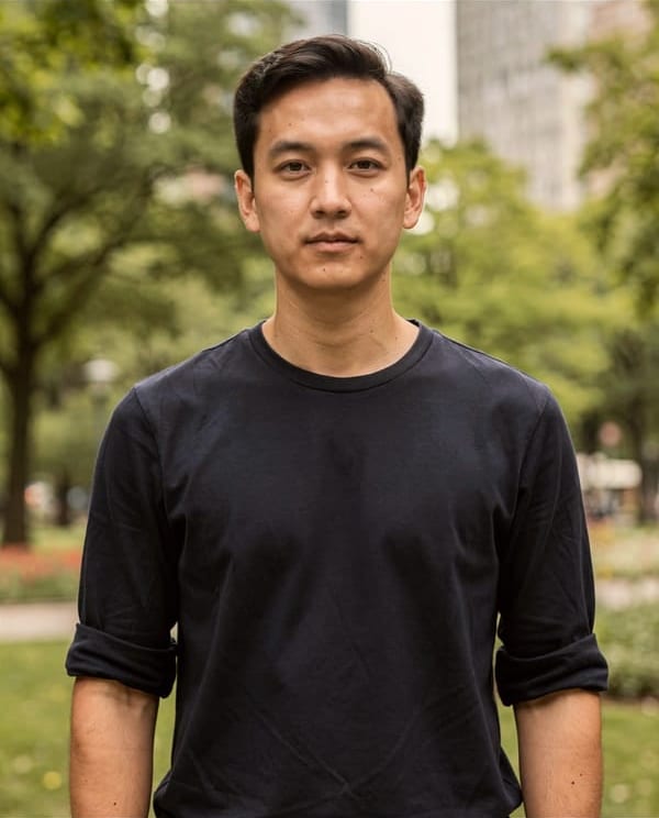 A young man in a black T-shirt in a park, before and after Backdrop with Office: the park behind him is replaced by a softly blurred office, and he is as he was.